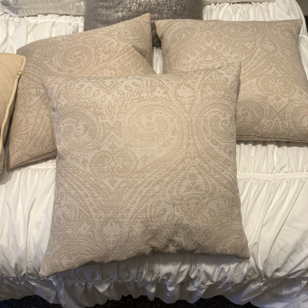 3 tan and gold throw pillows